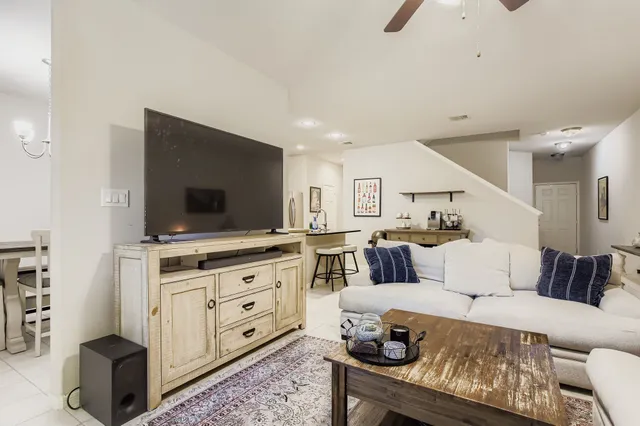 a living room with dining table and wooden floor