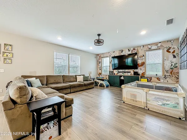 a living room with furniture and kitchen view