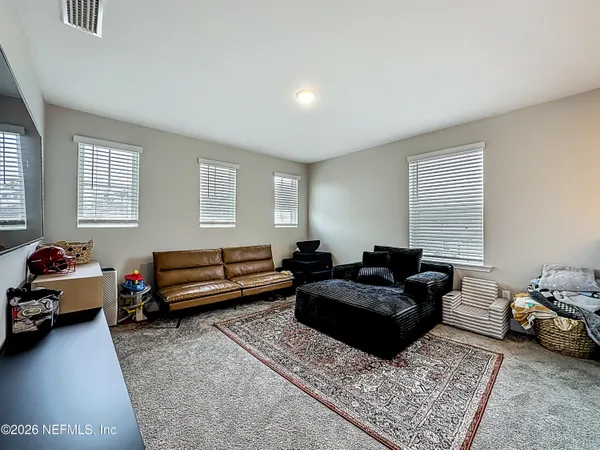 a living room with furniture and a rug