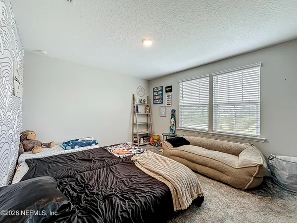 a bedroom with a bed and a couch