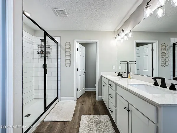 a view of a hallway with closet and wooden floor