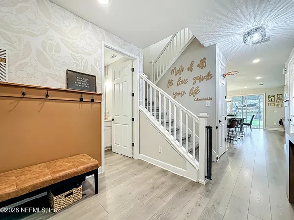 a view of a livingroom with wooden floor and stairs
