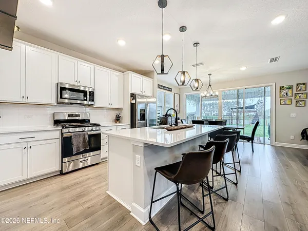 a kitchen with lots of counter space and dining table