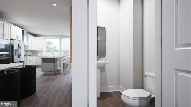 a bathroom with a sink a toilet a mirror and a window