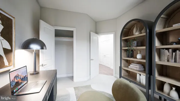 a living room with furniture and a book shelf