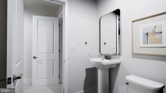 a bathroom with a sink mirror and toilet