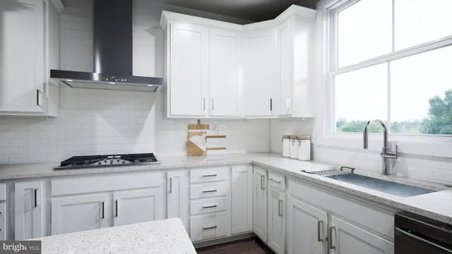 a kitchen with stainless steel appliances a sink a stove and white cabinets