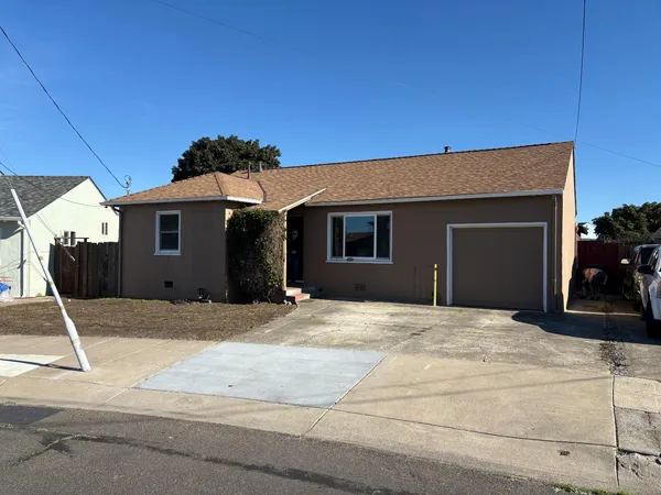 a front view of a house with garage