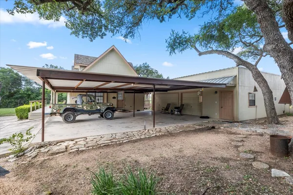 a view of a house with backyard and sitting area