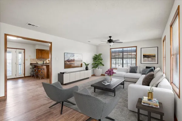 a living room with furniture and a wooden floor
