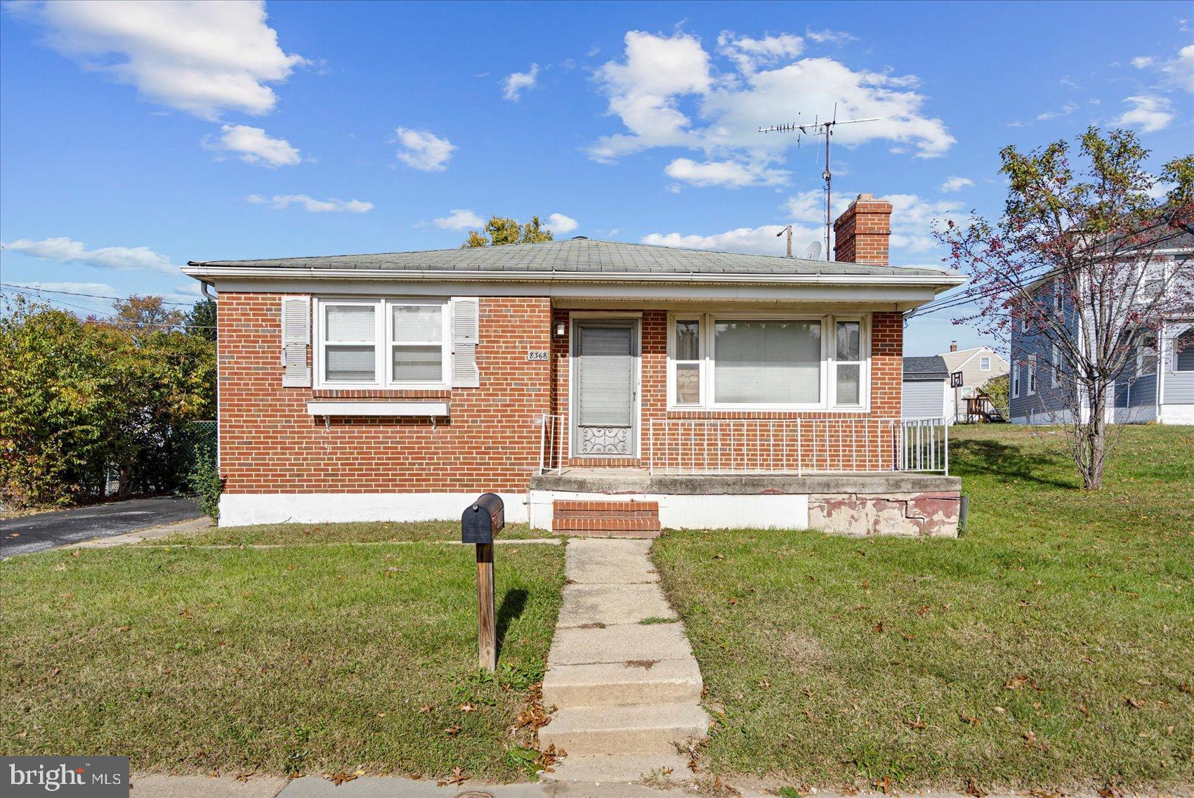 8368 Old Philadelphia Road Baltimore, MD 21237 - Photo 1 of 29 a front view of a house with a yard and garage