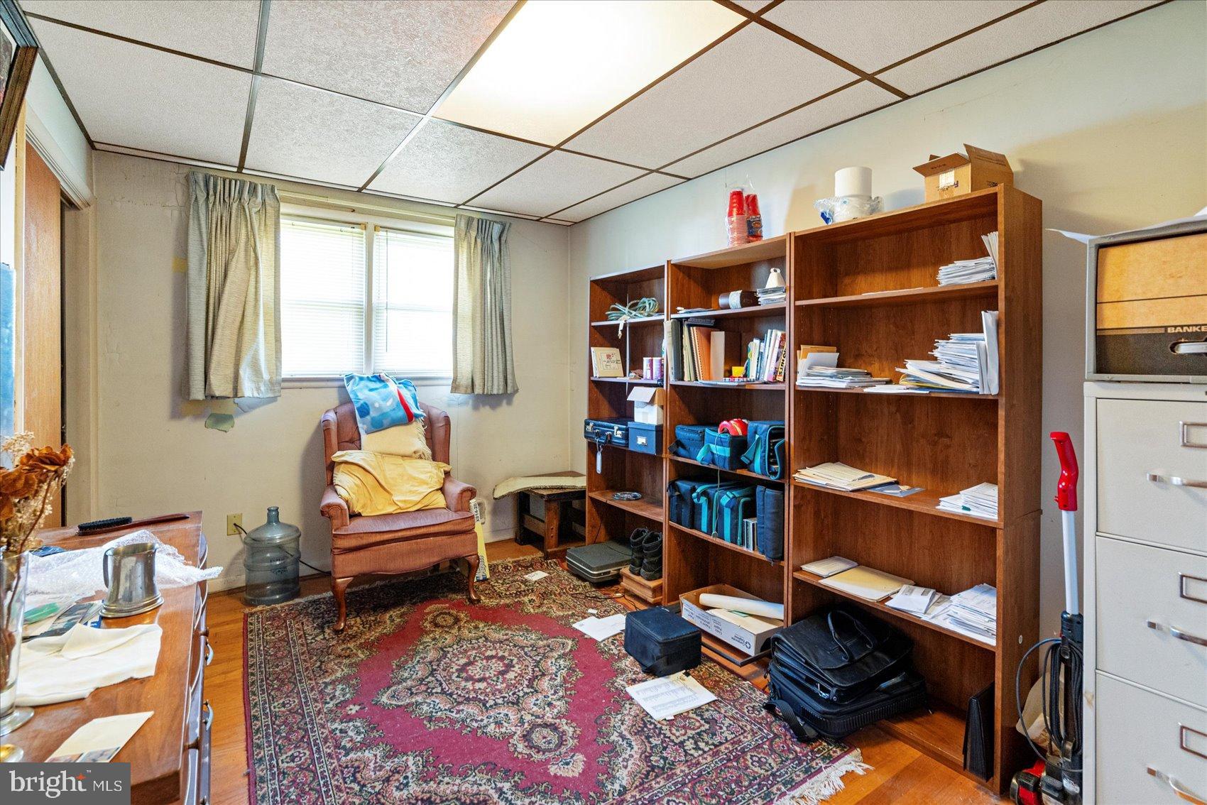 8368 Old Philadelphia Road Baltimore, MD 21237 - Photo 18 of 29 a living room with furniture a rug and a book shelf