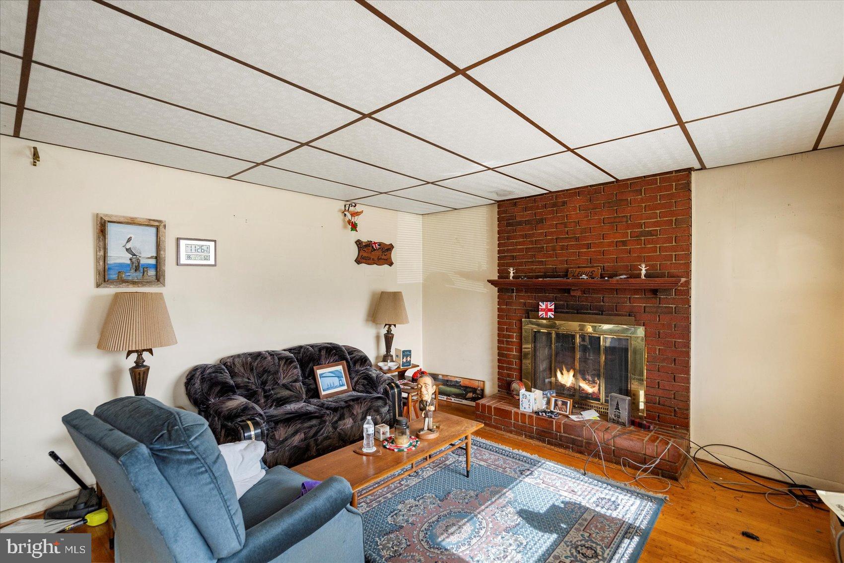8368 Old Philadelphia Road Baltimore, MD 21237 - Photo 8 of 29 a living room with furniture and a fireplace
