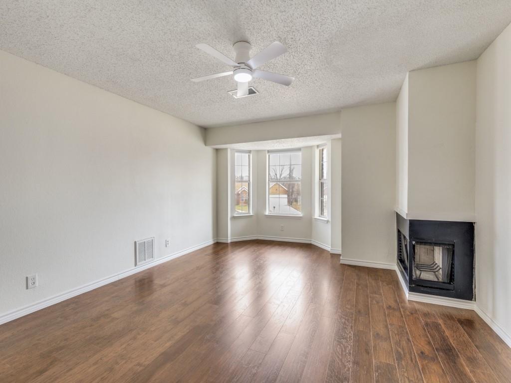 4657 Misty Ridge Drive Fort Worth, TX 76137 - Photo 13 of 25 The primary bedroom featues bay windows, a wood burning fireplace, and the flooring was replaced in 2026 !