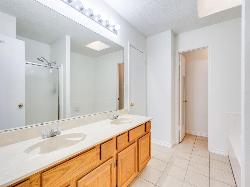 4657 Misty Ridge Drive Fort Worth, TX 76137 - Photo 16 of 25 Other fetures of the primary bath are dual sinks, a water closet, built-in cabinetry and a skylight !
