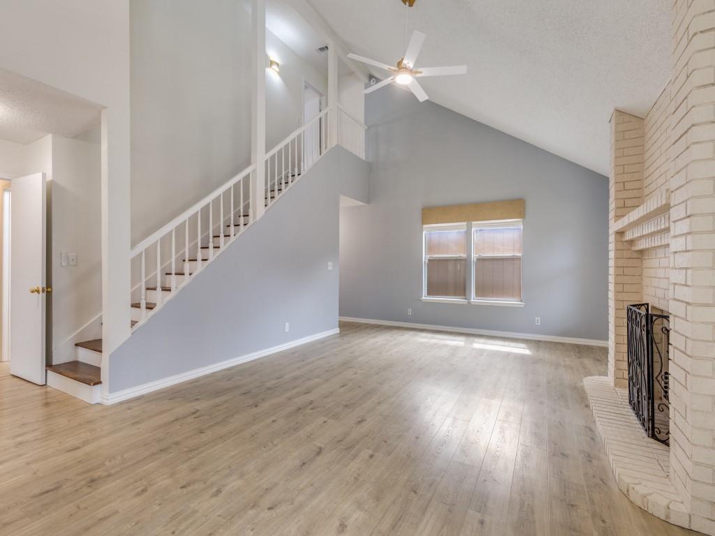 4657 Misty Ridge Drive Fort Worth, TX 76137 - Photo 5 of 25 The living room is light, bright and open with vaulted ceilings, a wood burning fireplace and a recently replaced ceiling fan !