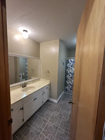a bathroom with a double vanity sink and mirror