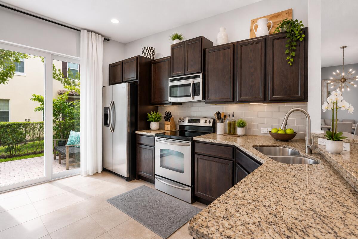 468 Francesca Ridge Road Boynton Beach, FL 33435 - Photo 4 of 11 a kitchen with stainless steel appliances granite countertop a refrigerator sink and cabinets