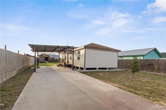 a view of a house with backyard and sitting area