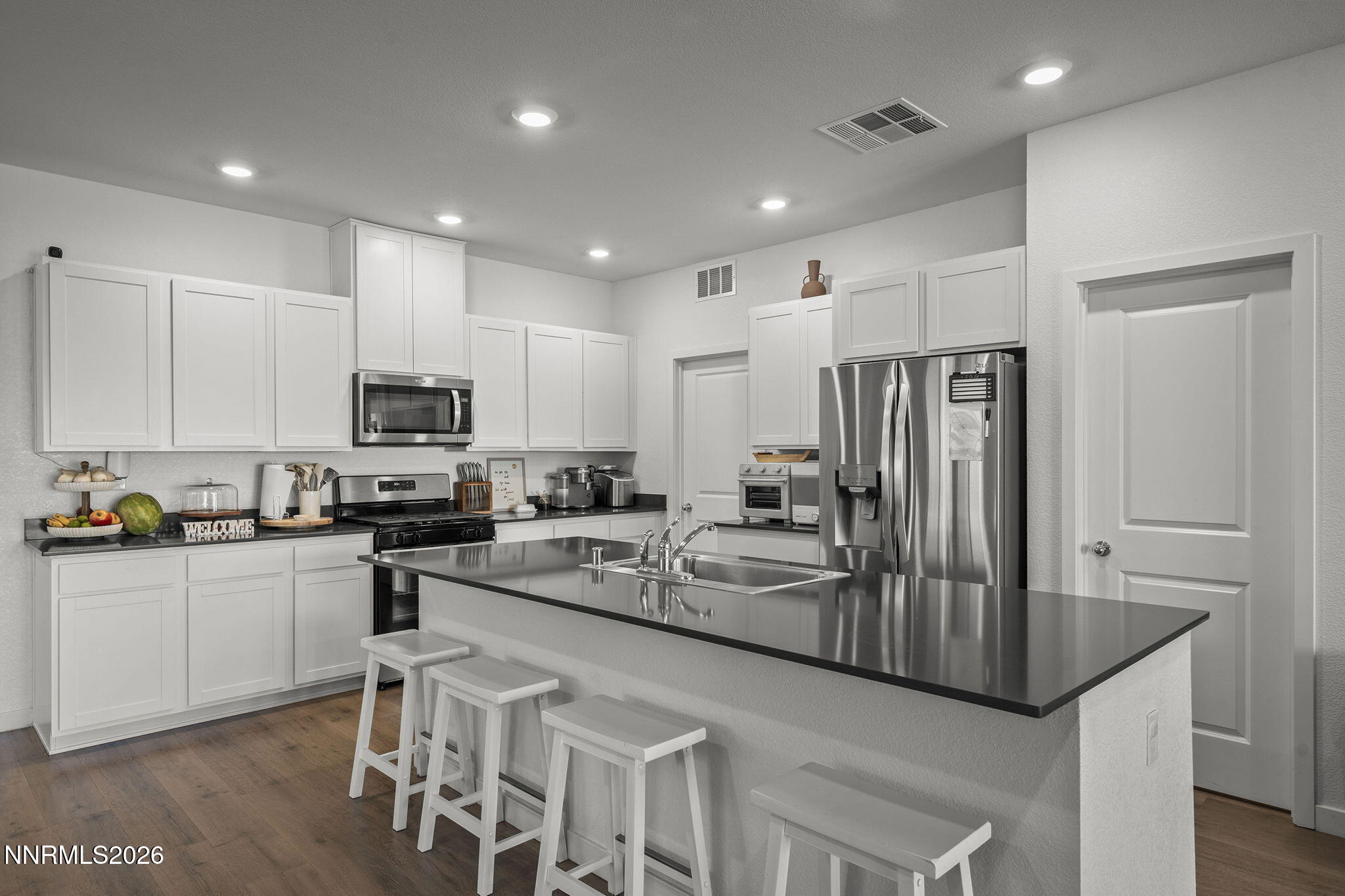 738 Butte Creek Road Dayton, NV 89403 - Photo 4 of 28 a kitchen with white cabinets and stainless steel appliances
