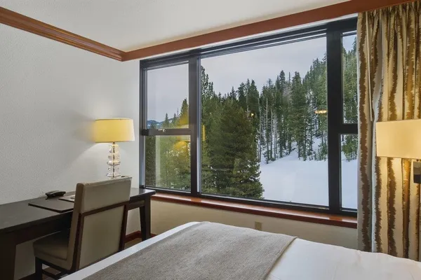 a view of a room with a large window and chair