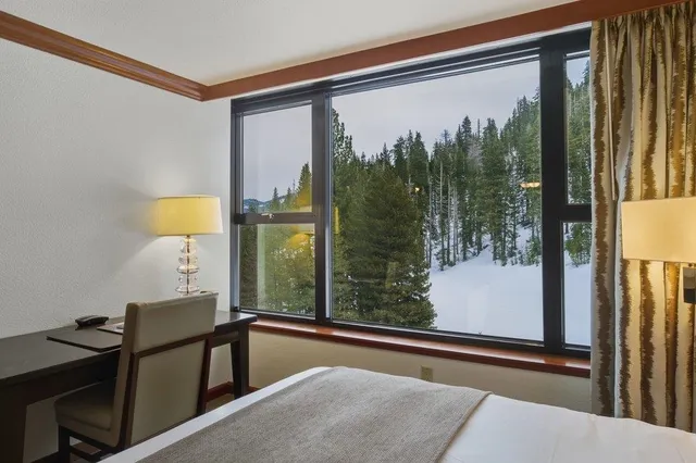 a view of a room with a large window and chair