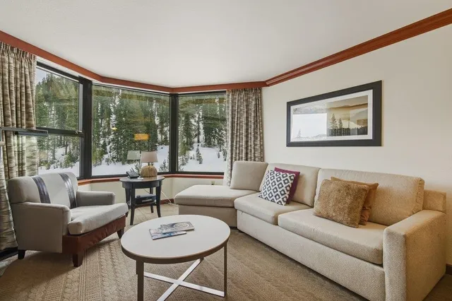 a living room with furniture and a large window