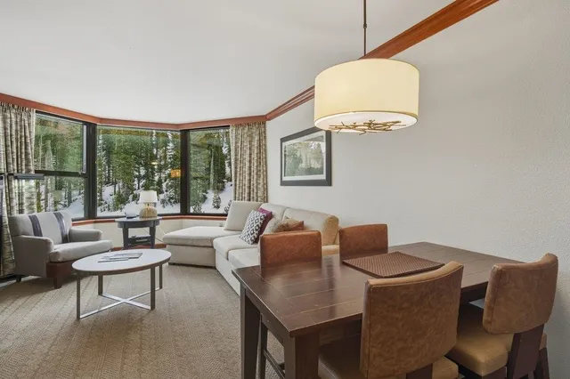 a living room with furniture and a floor to ceiling window