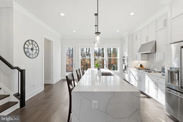a living room with furniture a flat screen tv and a dining table