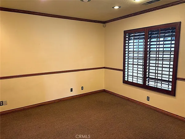 a view of a room with window and a ceiling fan