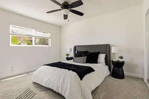 a bedroom with a bed and ceiling fan