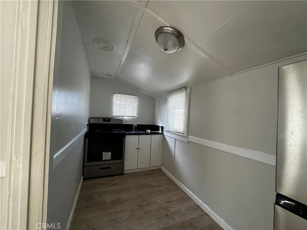 a kitchen with a refrigerator and a stove