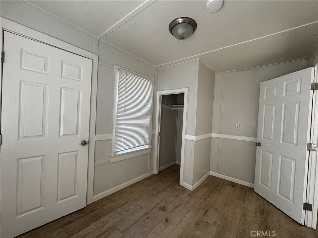 4036 4th Street Riverside, CA 92501 - Photo 4 of 10 an empty room with wooden floor and windows