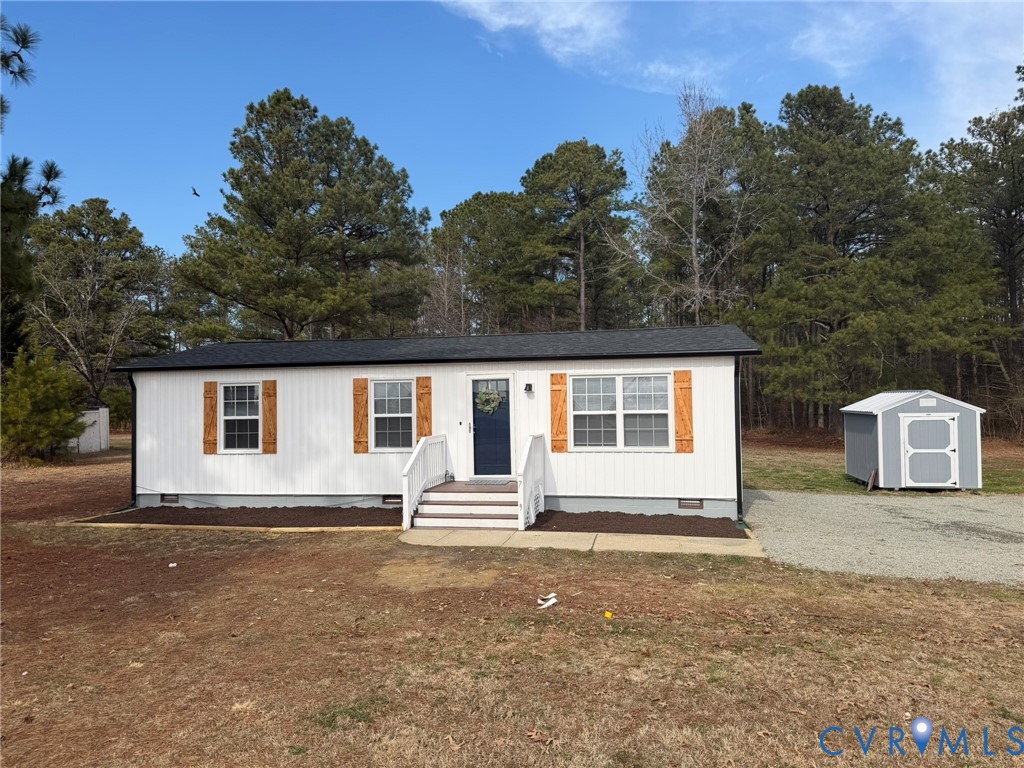 7279 Howerton Road Dunnsville, VA 22454 - Photo 1 of 17 a front view of a house with a yard