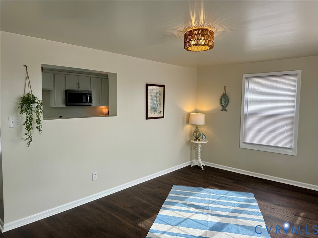7279 Howerton Road Dunnsville, VA 22454 - Photo 3 of 17 a front view of a house with wooden floor a potted plant and a chandelier