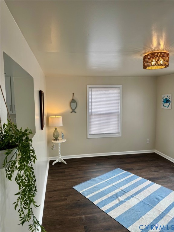 7279 Howerton Road Dunnsville, VA 22454 - Photo 4 of 17 a view of an empty room with wooden floor and a window