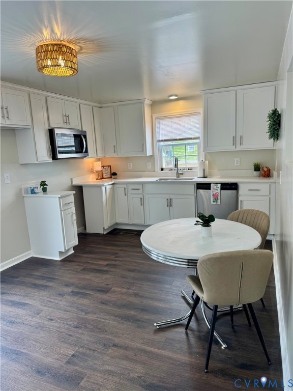 7279 Howerton Road Dunnsville, VA 22454 - Photo 5 of 17 a kitchen with a table chairs refrigerator and microwave