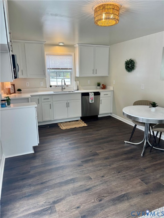 7279 Howerton Road Dunnsville, VA 22454 - Photo 6 of 17 a kitchen with stainless steel appliances a stove a sink white cabinets and a wooden floor