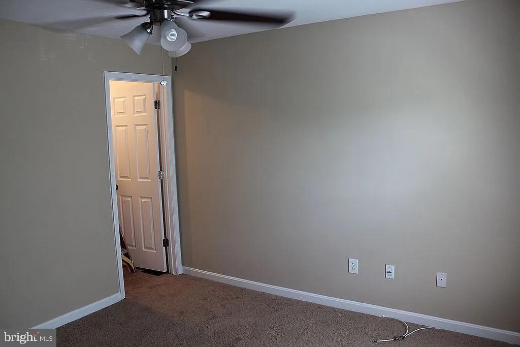 120 Langdon Farm Circle Odenton, MD 21113 - Photo 17 of 37 an empty room with a chandelier fan and a window
