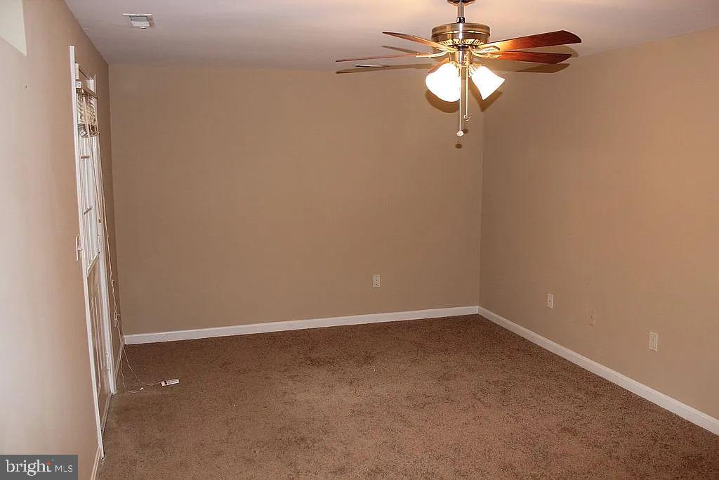 120 Langdon Farm Circle Odenton, MD 21113 - Photo 26 of 37 a view of a small space with wooden floor and a chandelier fan