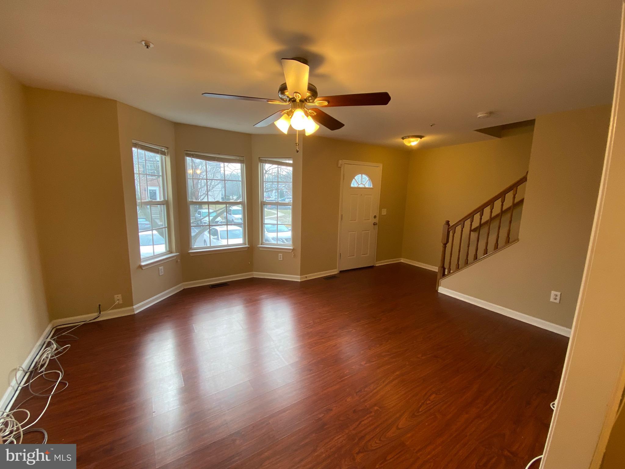 120 Langdon Farm Circle Odenton, MD 21113 - Photo 3 of 37 a view of an empty room with wooden floor and a window