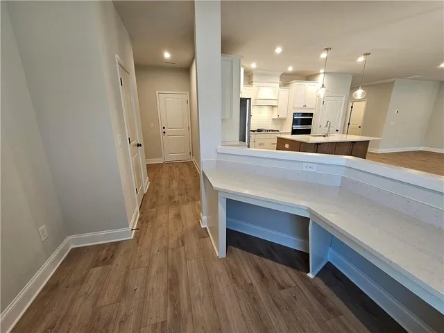 a view of kitchen with wooden floor and electronic appliances