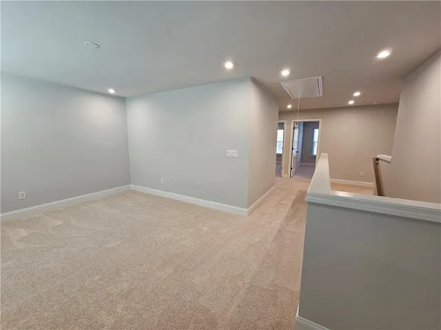 a view of a big room with kitchen and windows