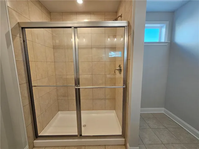 a bathroom with a glass shower door