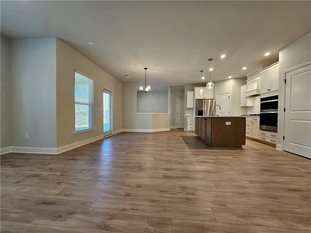 a view of a big room with kitchen and a window