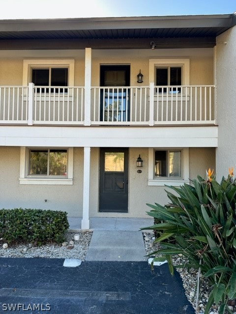 16710 Partridge Place Road, Unit 203 Fort Myers, FL 33908 - Photo 26 of 39 a front view of a house with plants