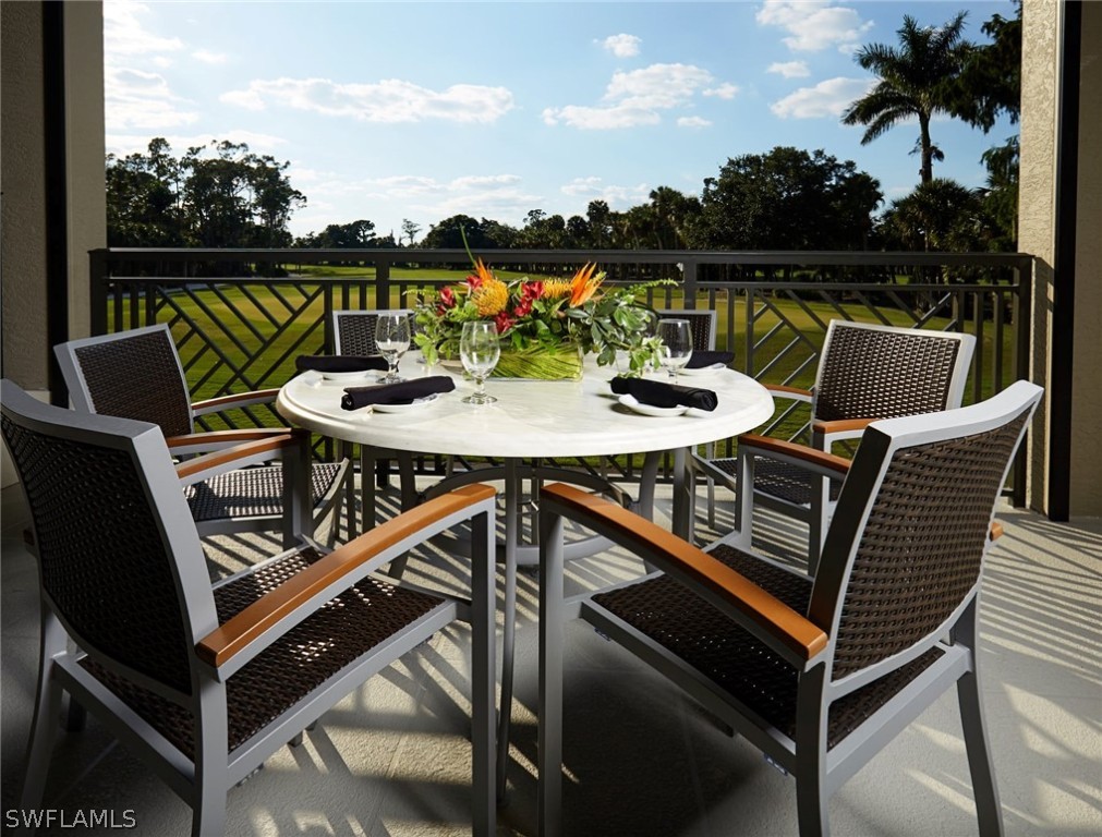 16710 Partridge Place Road, Unit 203 Fort Myers, FL 33908 - Photo 31 of 39 a view of a balcony with two chairs and a table