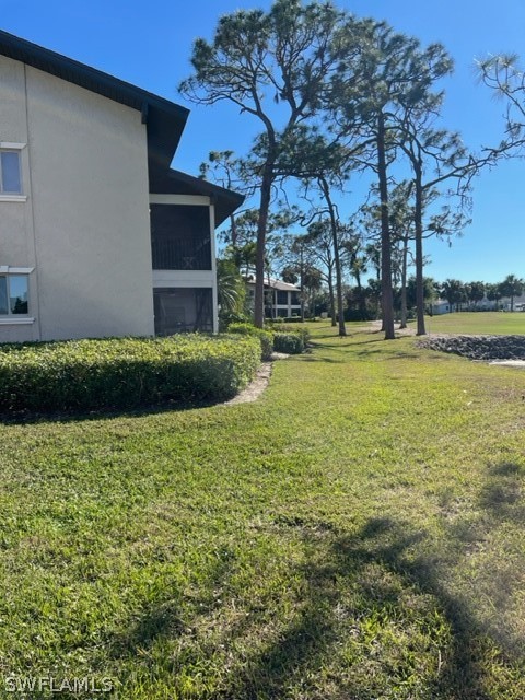 16710 Partridge Place Road, Unit 203 Fort Myers, FL 33908 - Photo 39 of 39 a view of a house with a yard and a large tree