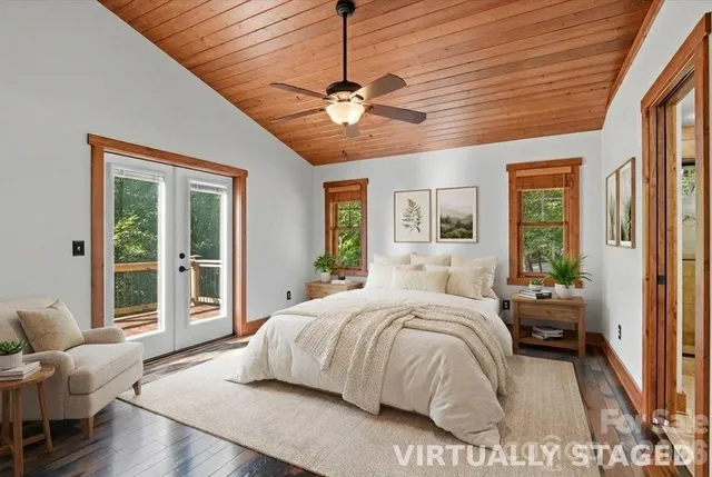 a bedroom with a large bed chandelier and a window