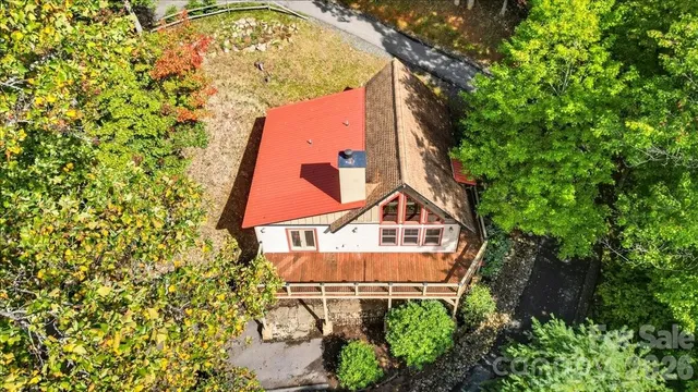 an aerial view of a house with a yard and garden